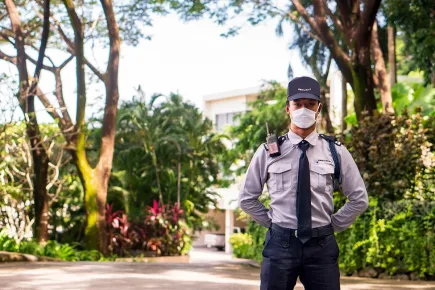 Professional TrustForce security guard in uniform on patrol outside a residential property in Doha, Qatar, reflecting the company's MOI-licensed, ISO-certified manned guarding standards.