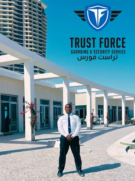 A trained Trust Force security officer providing professional guarding services at a commercial facility in Qatar.