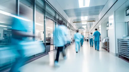 Busy hospital corridor with medical staff in motion, representing the fast-paced healthcare environments where TrustForce Security provides professional manned guarding and hospital security services across Qatar.