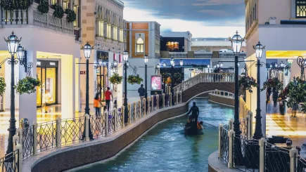 Interior of Villaggio Mall in Doha, Qatar, with shoppers walking alongside the iconic indoor canal, representing the high-footfall retail environments where TrustForce Security provides professional mall security services across Qatar.