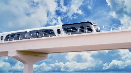 Modern elevated railway train against a blue sky, representing the public transport infrastructure where TrustForce Security provides professional manned guarding and railway security services across Qatar.