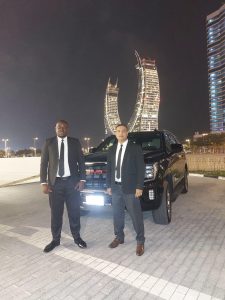 Professional close protection officers with secure vehicle providing evacuation escort in Doha