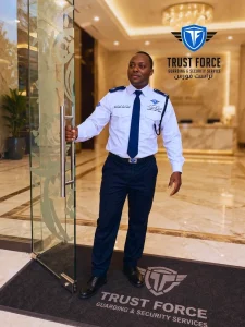 Uniformed TrustForce security guard standing at a hotel lobby entrance in Doha, Qatar