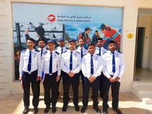 Group of uniformed TrustForce security guards standing together after completing security training in Qatar