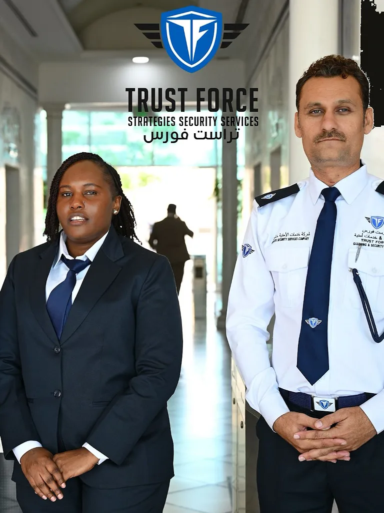 Two professional TrustForce security guards in uniform standing on duty at a commercial building in Doha, Qatar