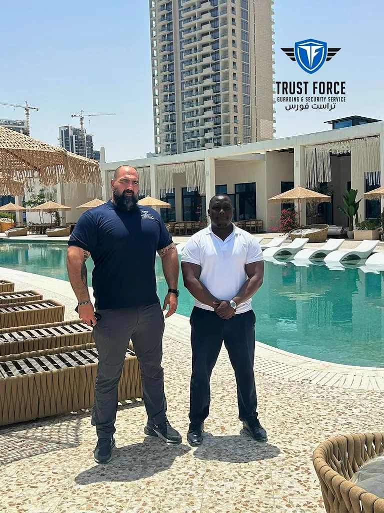 Two TrustForce security personnel conducting a site visit at a luxury pool and hospitality venue in Qatar